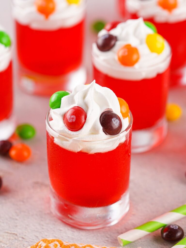 Top Jello Shots with Whipped Cream and Skittles