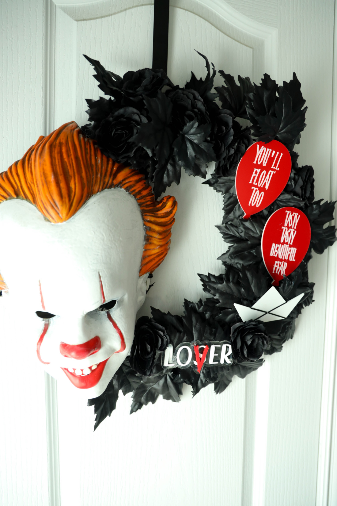 Creepy clown wreath with dark decorations