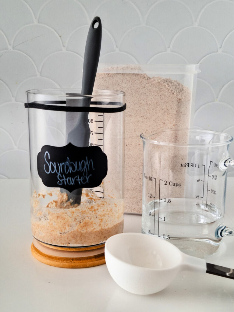 Sourdough starter with measuring tools nearby