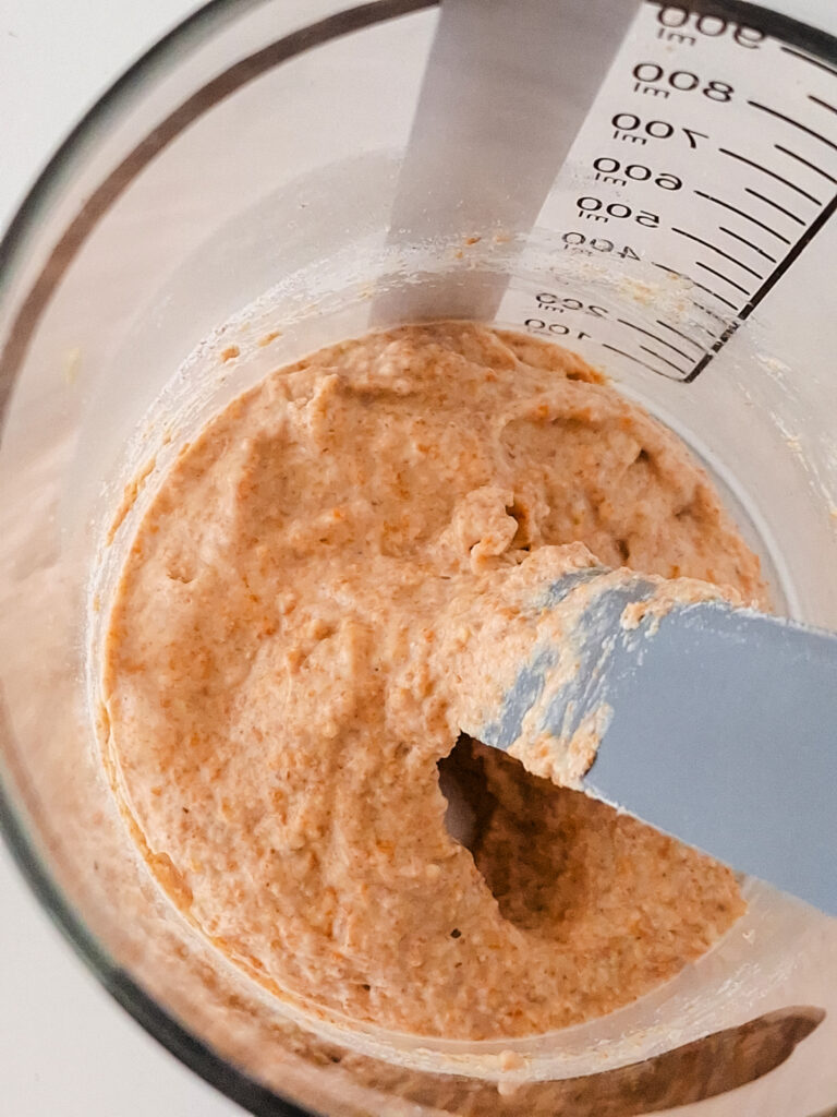 Thick, bubbly sourdough starter mixture.