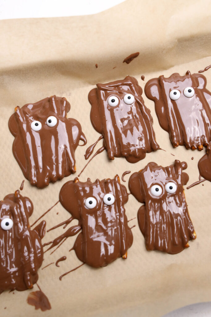 Chocolate-covered pretzels with candy eyes