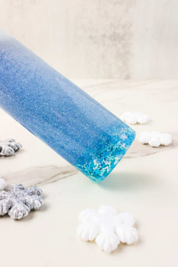 Blue glittery sensory bottle with snowflakes