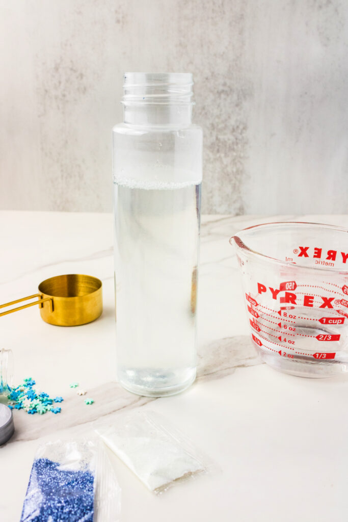 Clear bottle with water and glitter