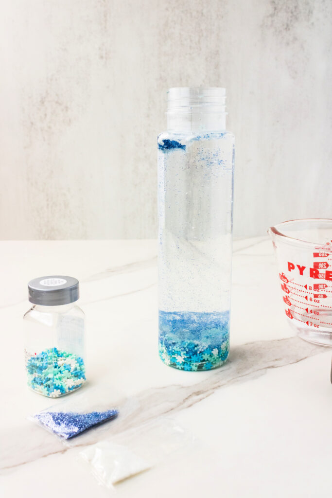 Clear bottle with blue glitter and water Snowflake Sensory Bottle