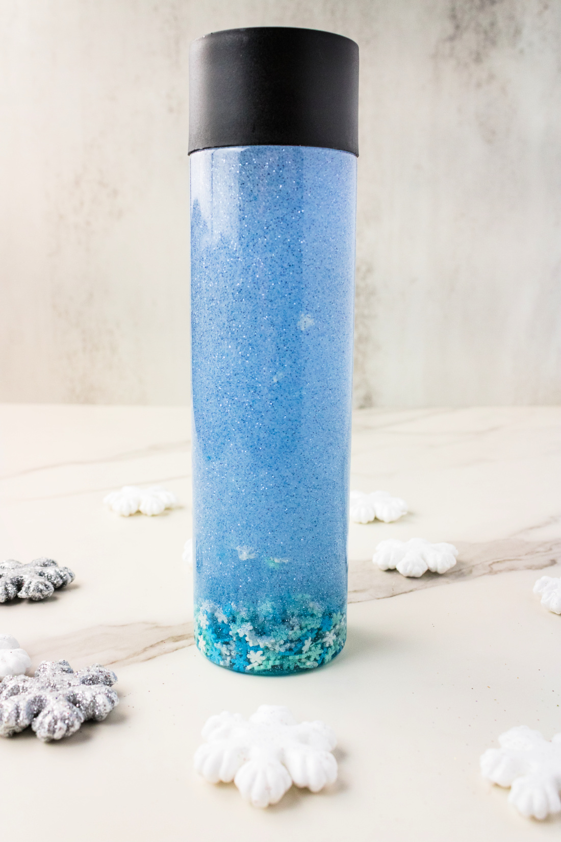 Blue glitter sensory bottle with snowflakes